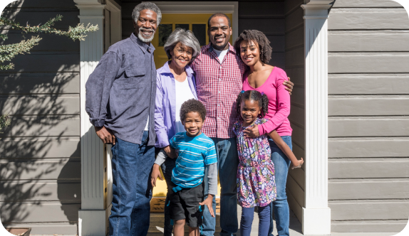 happy family in front of house